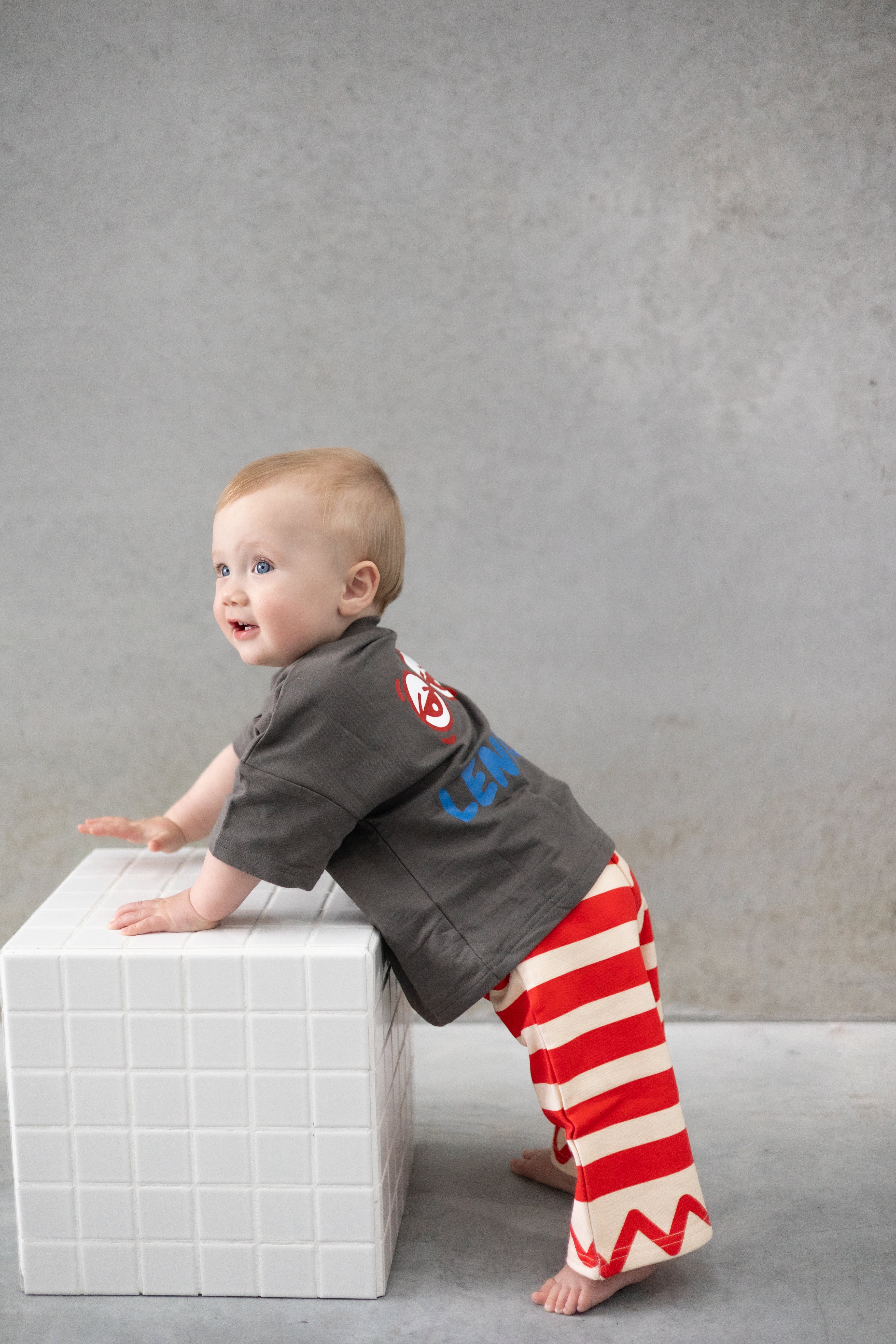 baby and child in red striped pants