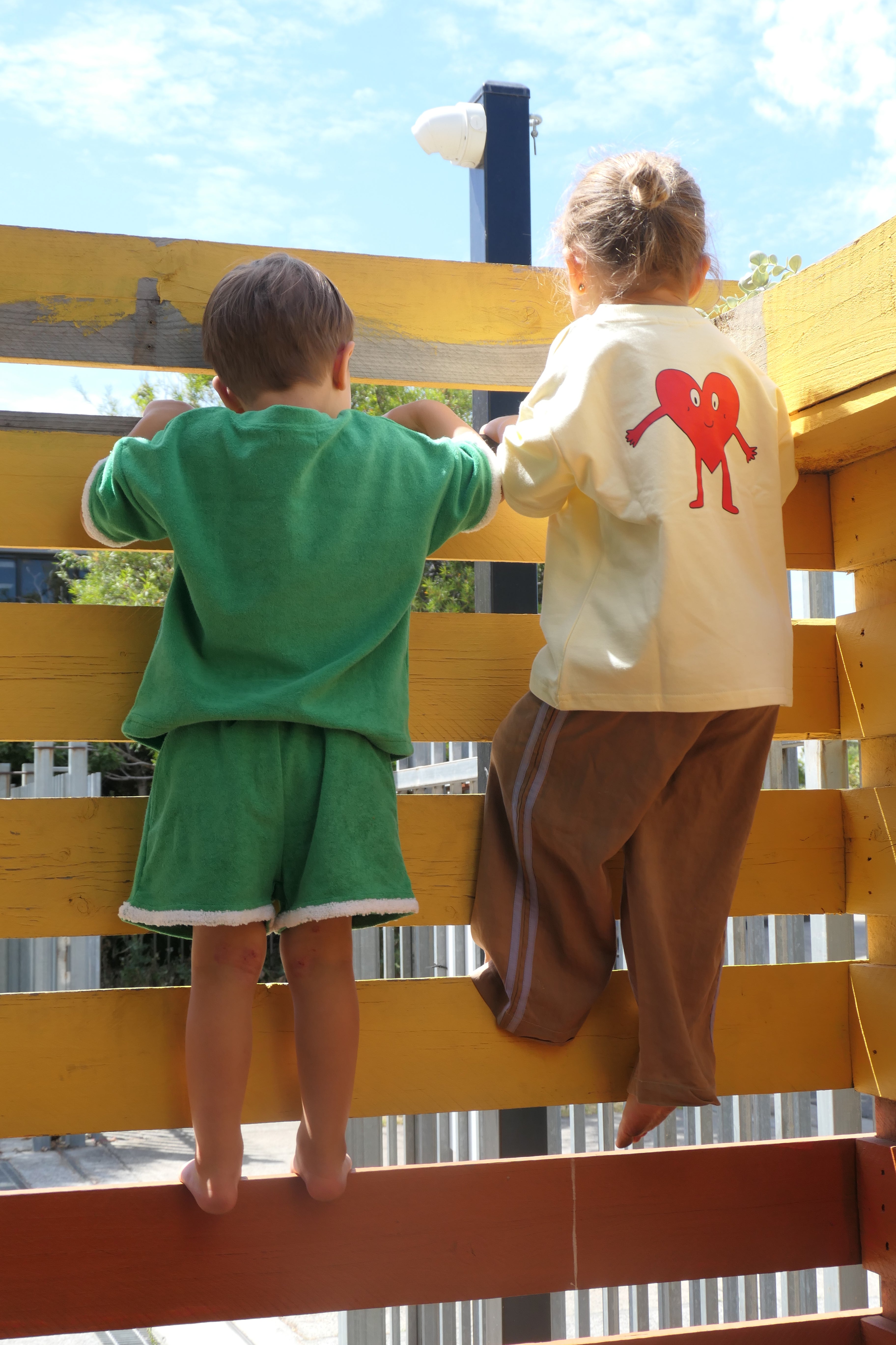 Kids playing on outdoor play equipment wearing Lennyco. and terry towelling outfit